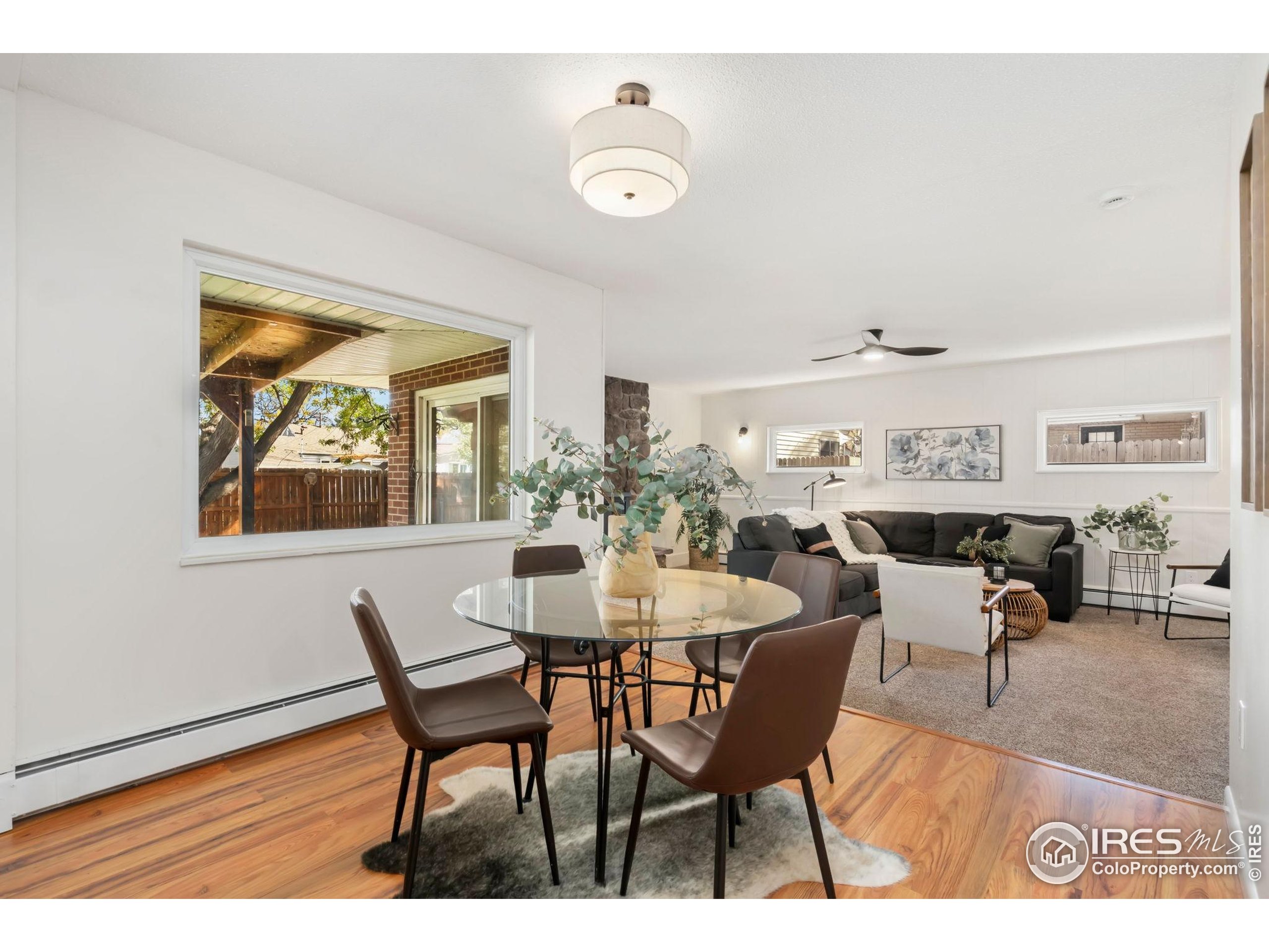 435 Birch Avenue Eaton, CO 80615 - Photo 10 of 32 a view of a dining room with furniture a rug and wooden floor