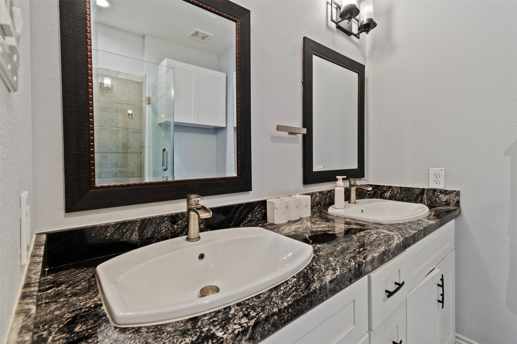 6706 Lozier Street Houston, TX 77021 - Photo 11 of 32 a bathroom with a double vanity sink and a mirror