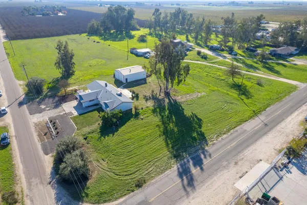 a front view of a house with swimming pool having outdoor seating