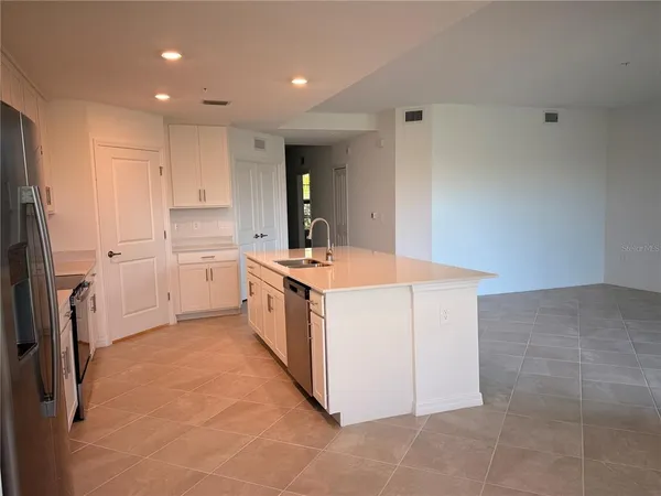 a kitchen with a sink stove and refrigerator