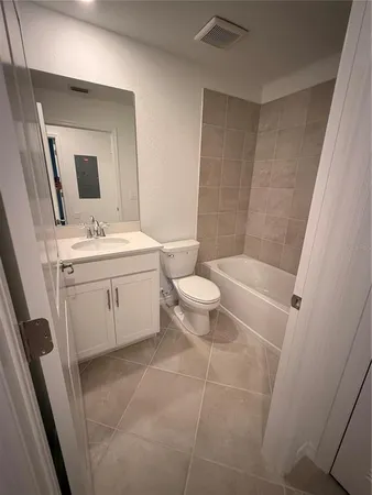a bathroom with a sink a toilet and mirror