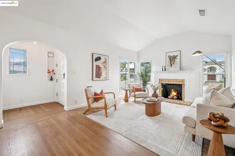 a living room with furniture and a clock
