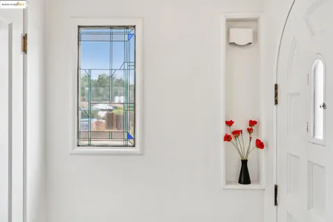 a view of a dining room with furniture and a chandelier fan