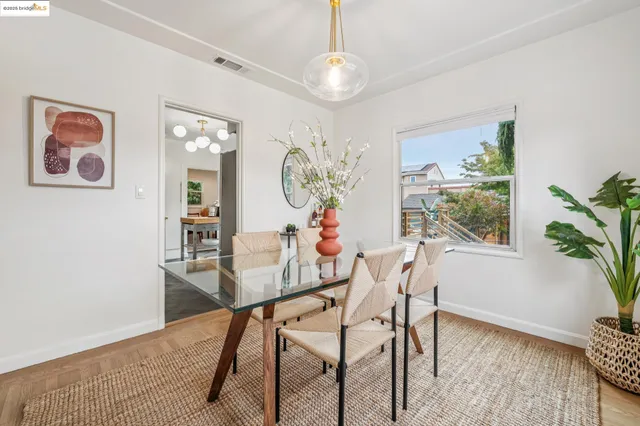 a kitchen that has a lot of white cabinets and stainless steel appliances