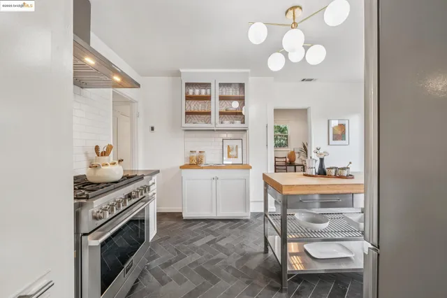 a kitchen with a refrigerator a table and chairs