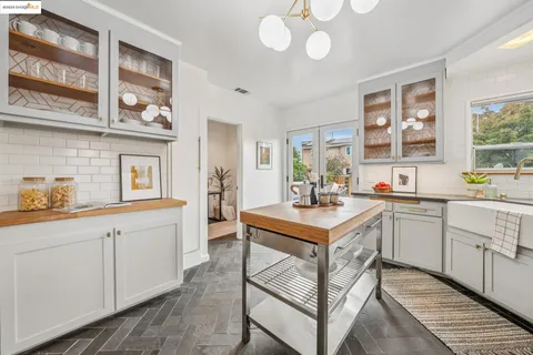 a stove top oven sitting inside of a kitchen