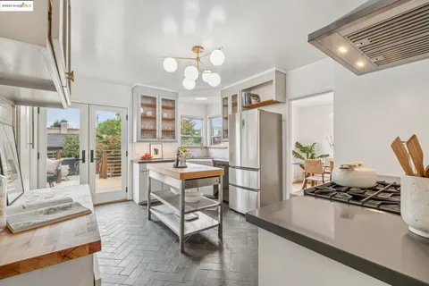 a large white kitchen with a stove a sink and dishwasher