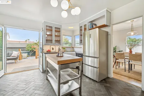 a kitchen with a stove a sink and a refrigerator
