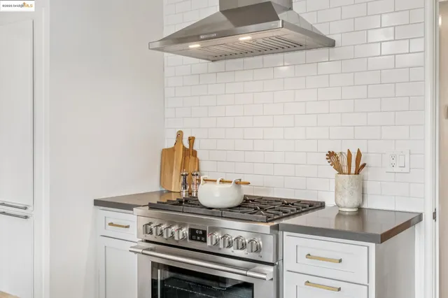a stove top oven sitting inside of a kitchen