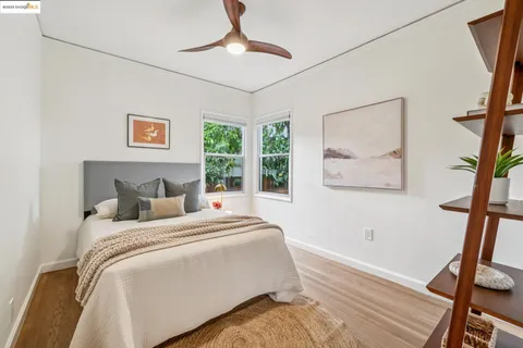 a spacious bedroom with a bed a chandelier and a window