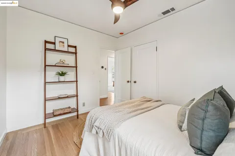 a bedroom with a bed and window with chair