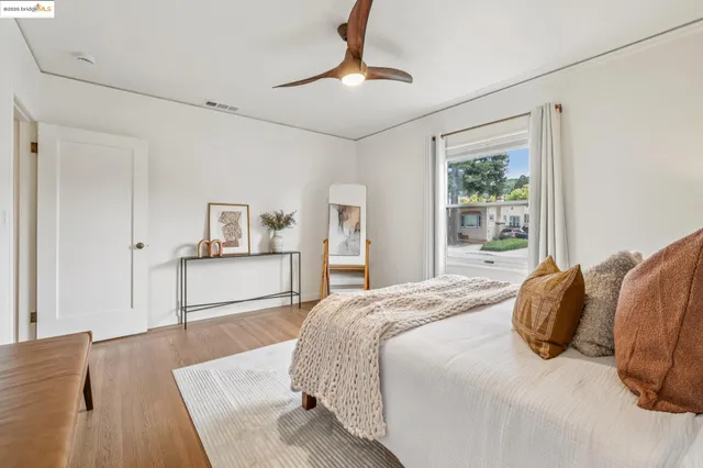 a view of a chair and table in backyard of the house