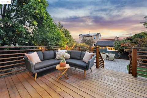 a view of a patio with couches and a fire pit and a fire pit