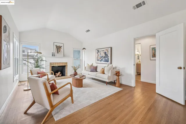 a living room with furniture a fireplace and a table