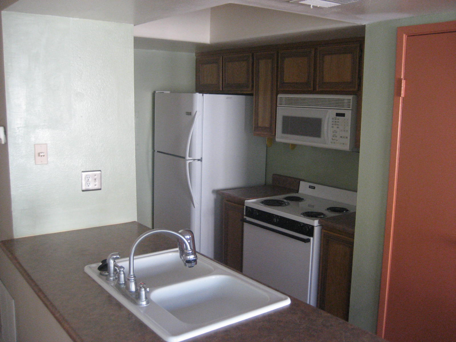 72724 Eagle Road, Unit 2 Palm Desert, CA 92260 - Photo 6 of 29 a kitchen with a refrigerator sink and stove