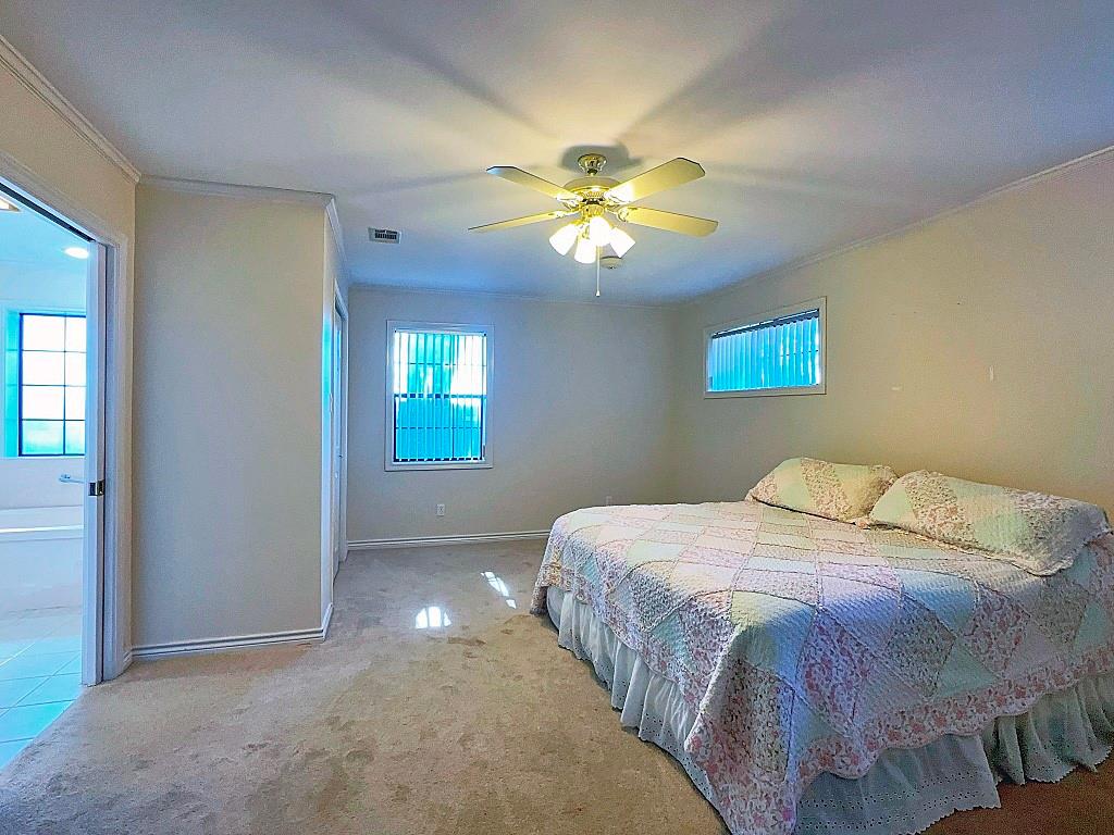 810 Toribrooke Athens, TX 75751 - Photo 9 of 18 a bedroom with a bed and a chandelier