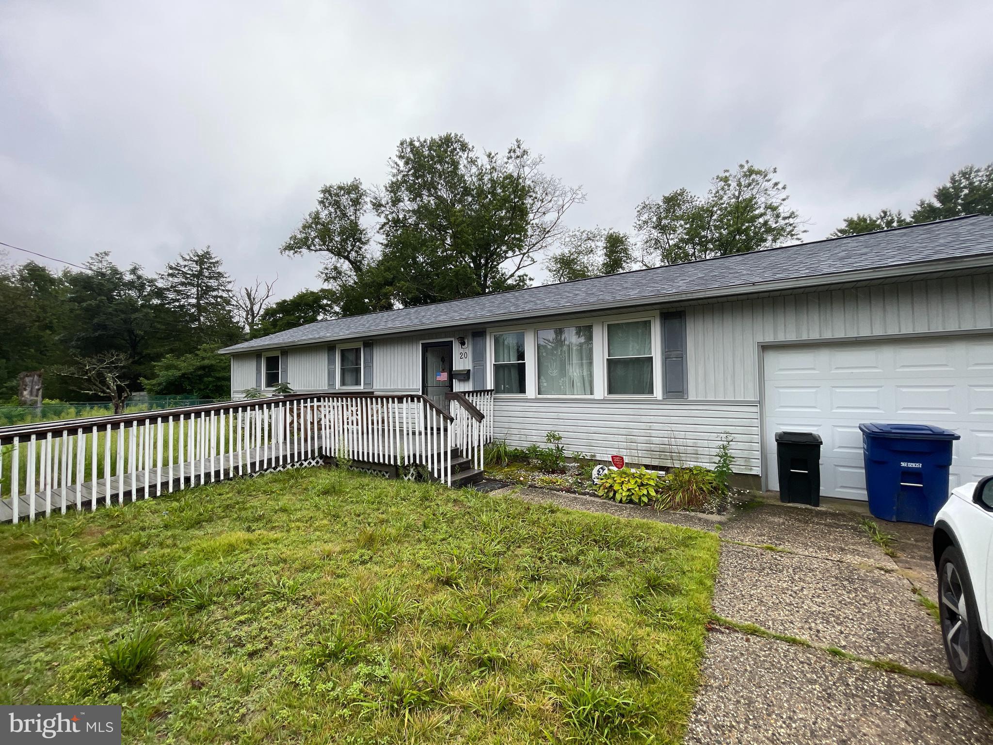 a view of a house with a yard and porch