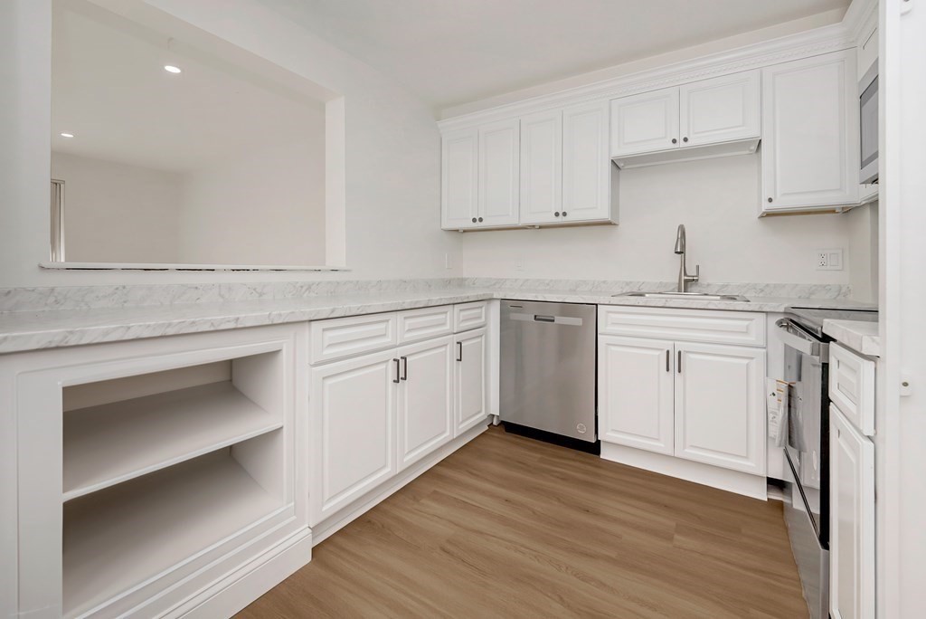 45 Oval Road, Unit 12 Quincy, MA 02170 - Photo 2 of 12 a kitchen with a sink cabinets and wooden floor