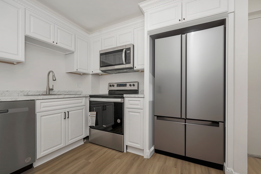 45 Oval Road, Unit 12 Quincy, MA 02170 - Photo 3 of 12 a kitchen with a refrigerator stove and sink