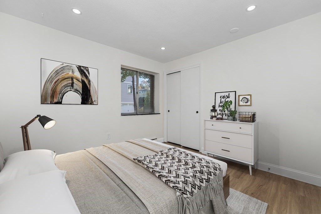 45 Oval Road, Unit 12 Quincy, MA 02170 - Photo 4 of 12 a bedroom with a bed and dresser