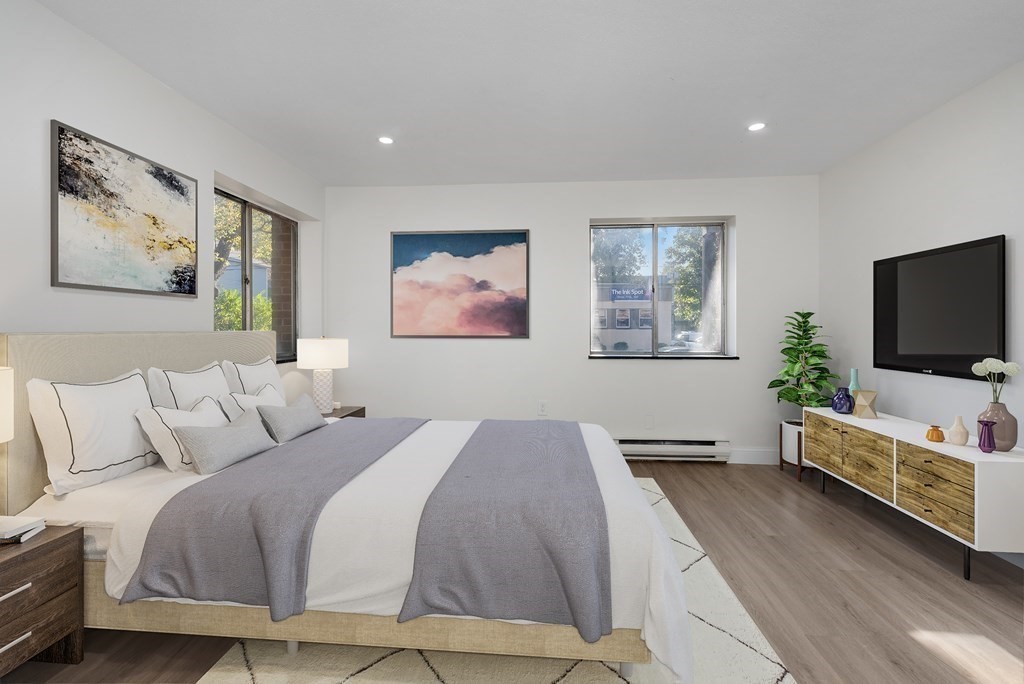 45 Oval Road, Unit 12 Quincy, MA 02170 - Photo 5 of 12 a bedroom with a bed and a flat screen tv