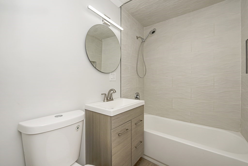 45 Oval Road, Unit 12 Quincy, MA 02170 - Photo 6 of 12 a bathroom with a sink a toilet and a bathtub