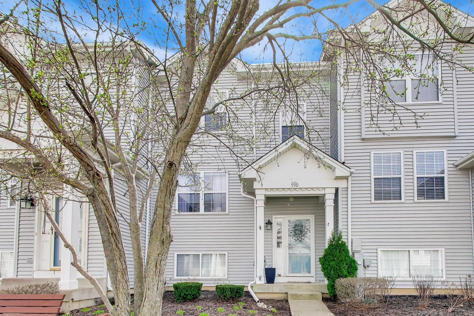 590 Triumph Court Hainesville, IL 60073 - Photo 1 of 25 a view of a white house with a large tree