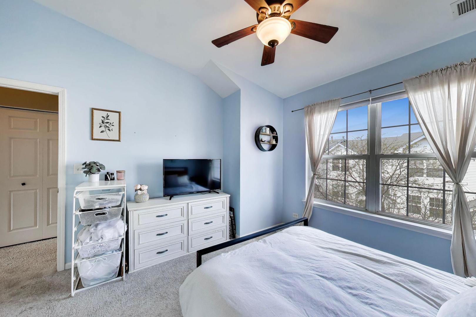 590 Triumph Court Hainesville, IL 60073 - Photo 15 of 25 a bedroom with a bed and a flat screen tv
