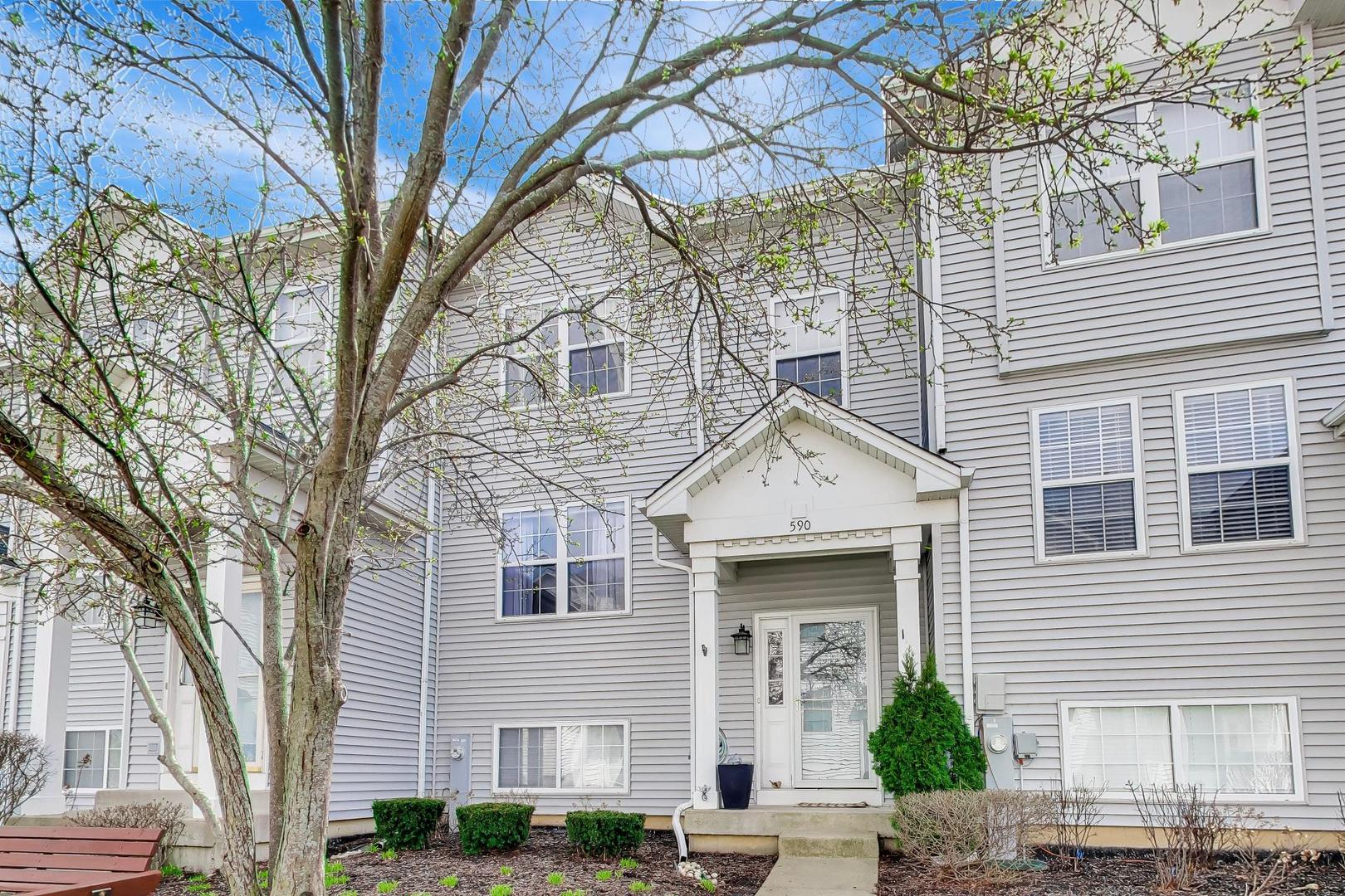 590 Triumph Court Hainesville, IL 60073 - Photo 2 of 25 a front view of a house with garden