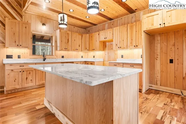 a kitchen with granite countertop a sink stove and cabinets