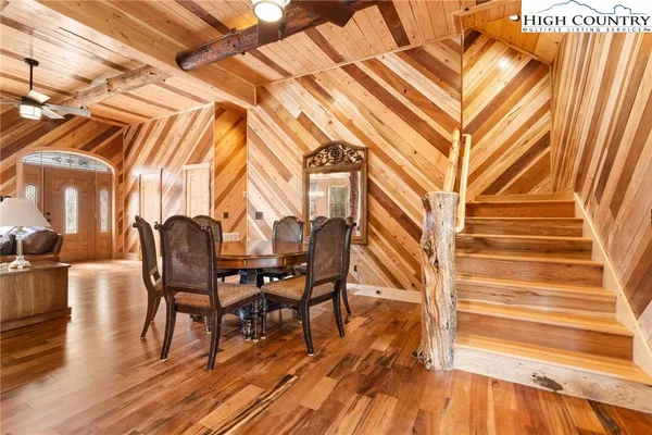 a dining room with furniture and wooden floor
