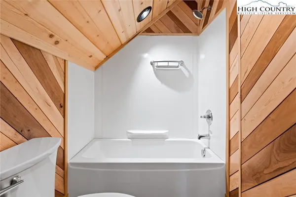 a bathroom with a bathtub and a window