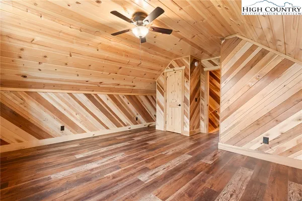 a view of a room with stairs and a white wooden floor