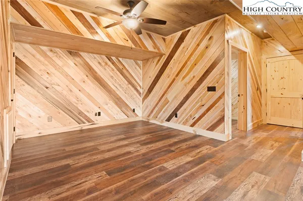 a view of a room with wooden floor