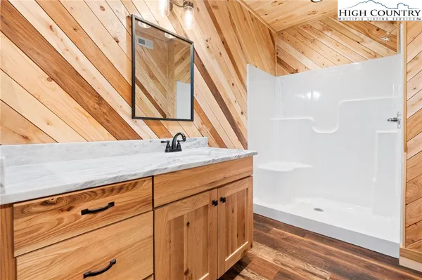 a view of a porch with wooden floor and fence