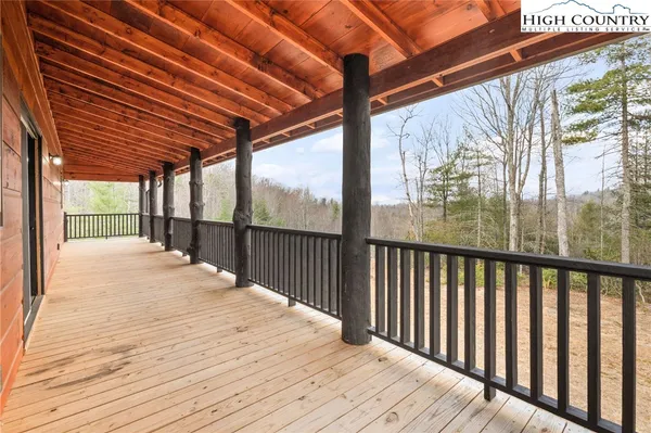 a view of a house with a yard and wooden fence