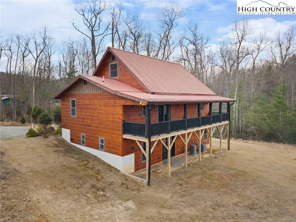 a view of house with backyard and outdoor seating