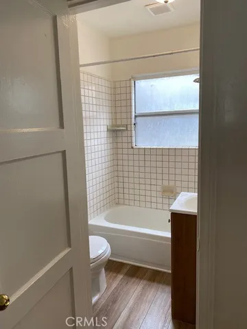 a bathroom with a toilet a sink and bathtub