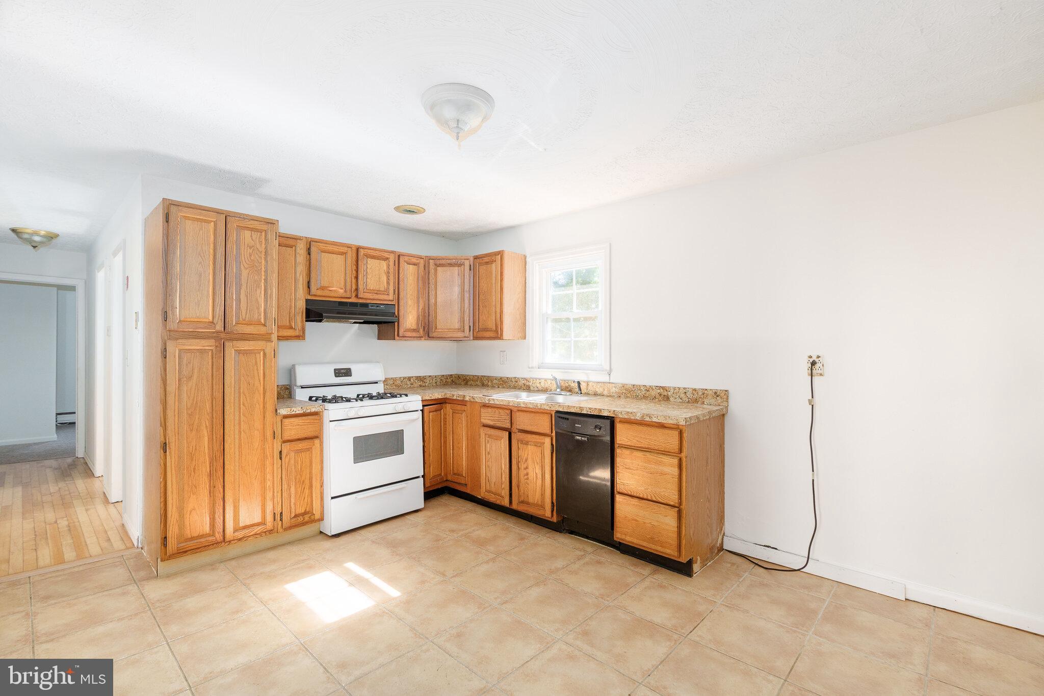 192 Barnes Corner Road Rising Sun, MD 21911 - Photo 5 of 17 a kitchen with stainless steel appliances granite countertop a stove and a refrigerator