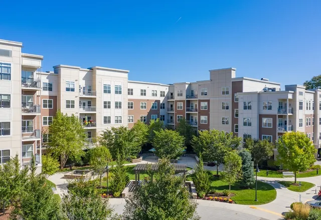 a view of a building with a yard and swimming pool