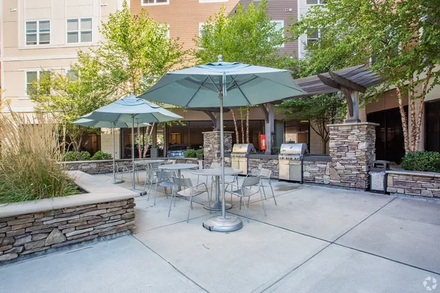 a view of a patio with chairs and table under an umbrella
