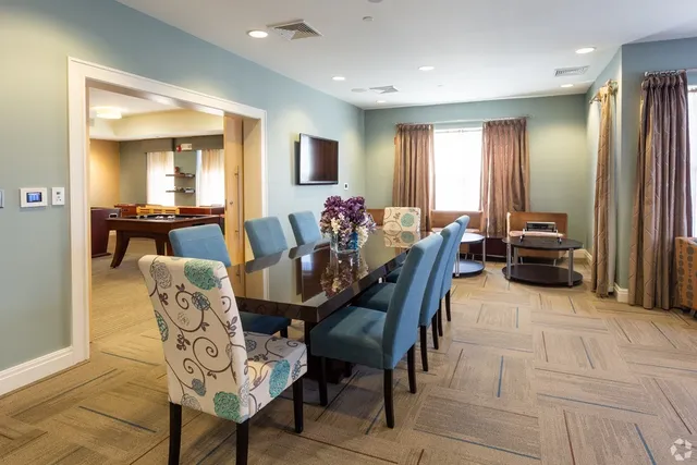 a view of a dining room with furniture and window