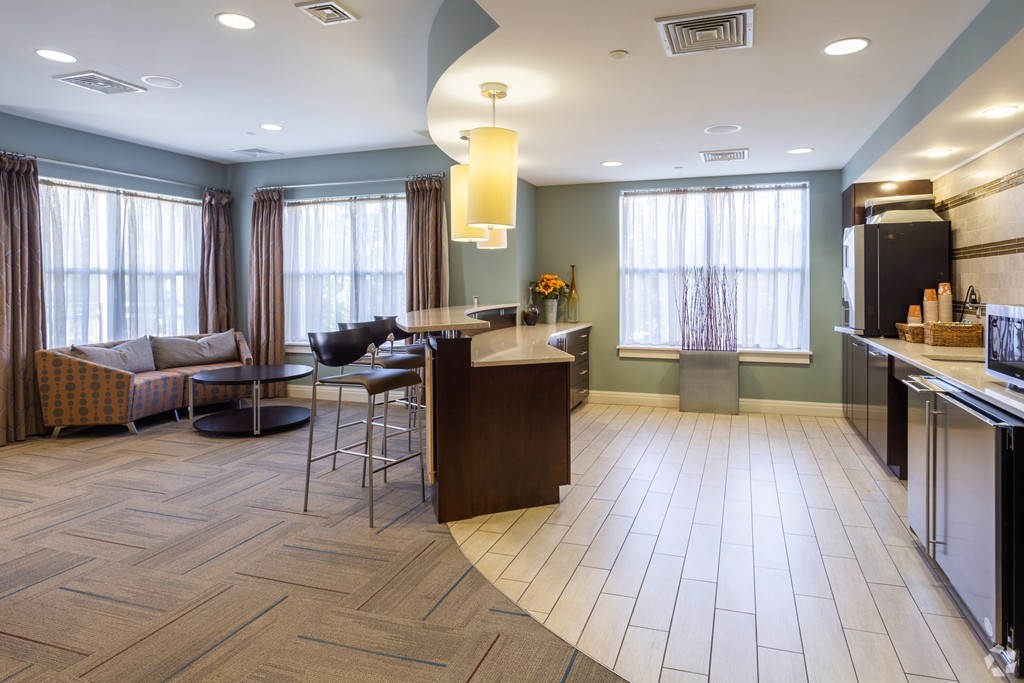 30 Mill Street, Unit 206 Arlington, MA 02476 - Photo 6 of 23 a living room with furniture and a wooden floor