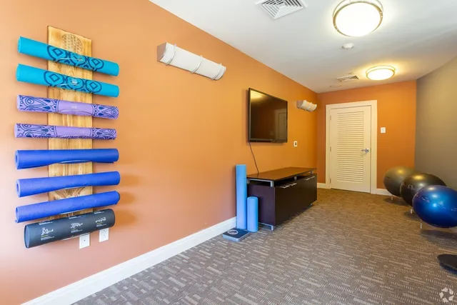 a kitchen with a wooden floor and a flat screen tv