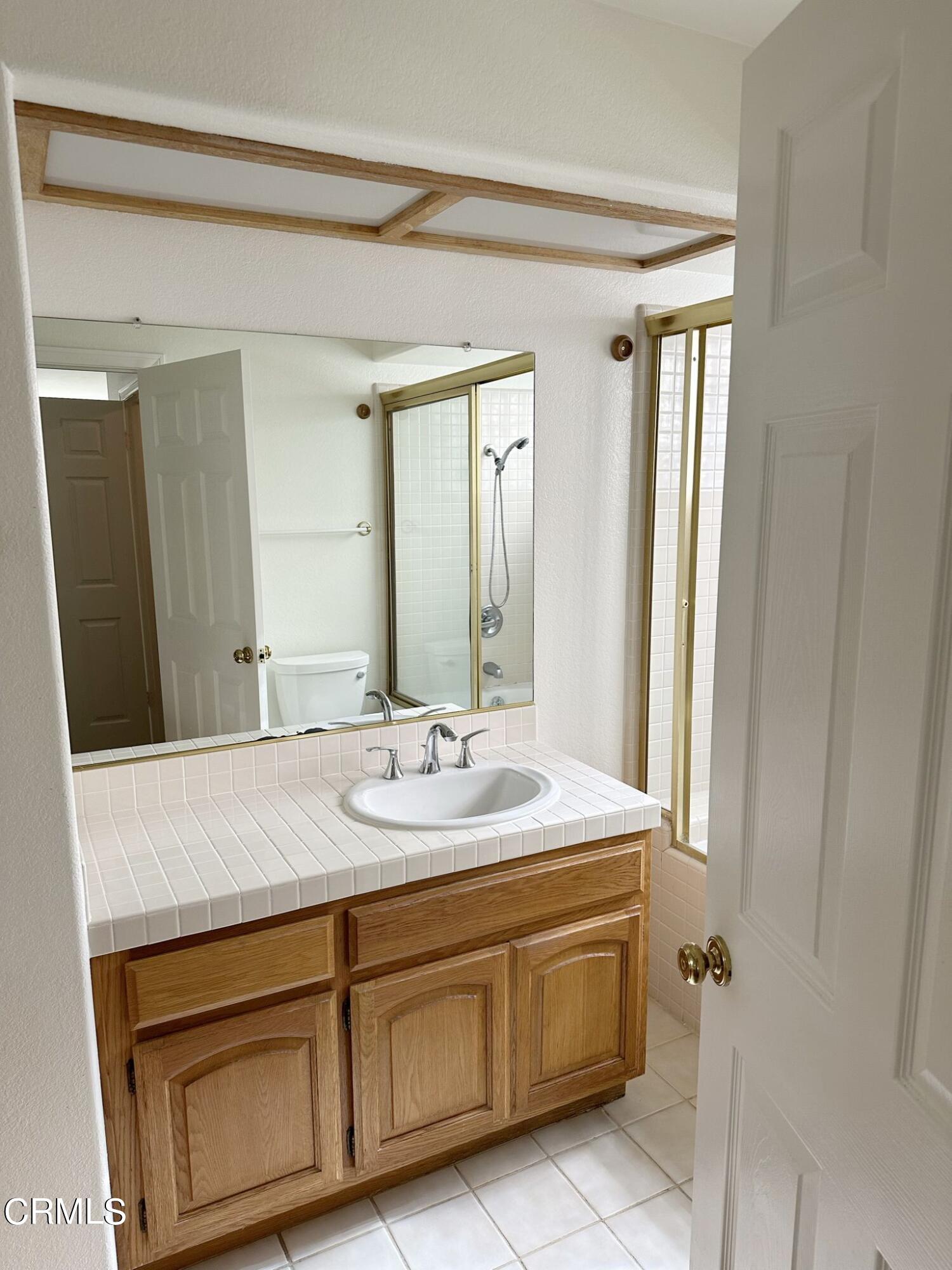 2190 Eastridge Loop Oxnard, CA 93036 - Photo 13 of 21 a bathroom with a granite countertop sink and a mirror