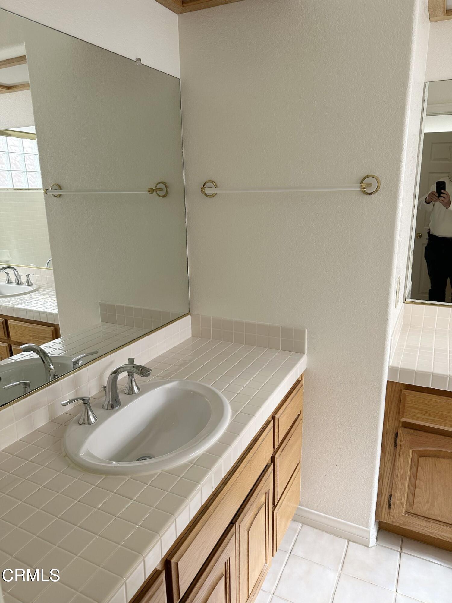 2190 Eastridge Loop Oxnard, CA 93036 - Photo 14 of 21 a bathroom with a sink and a mirror