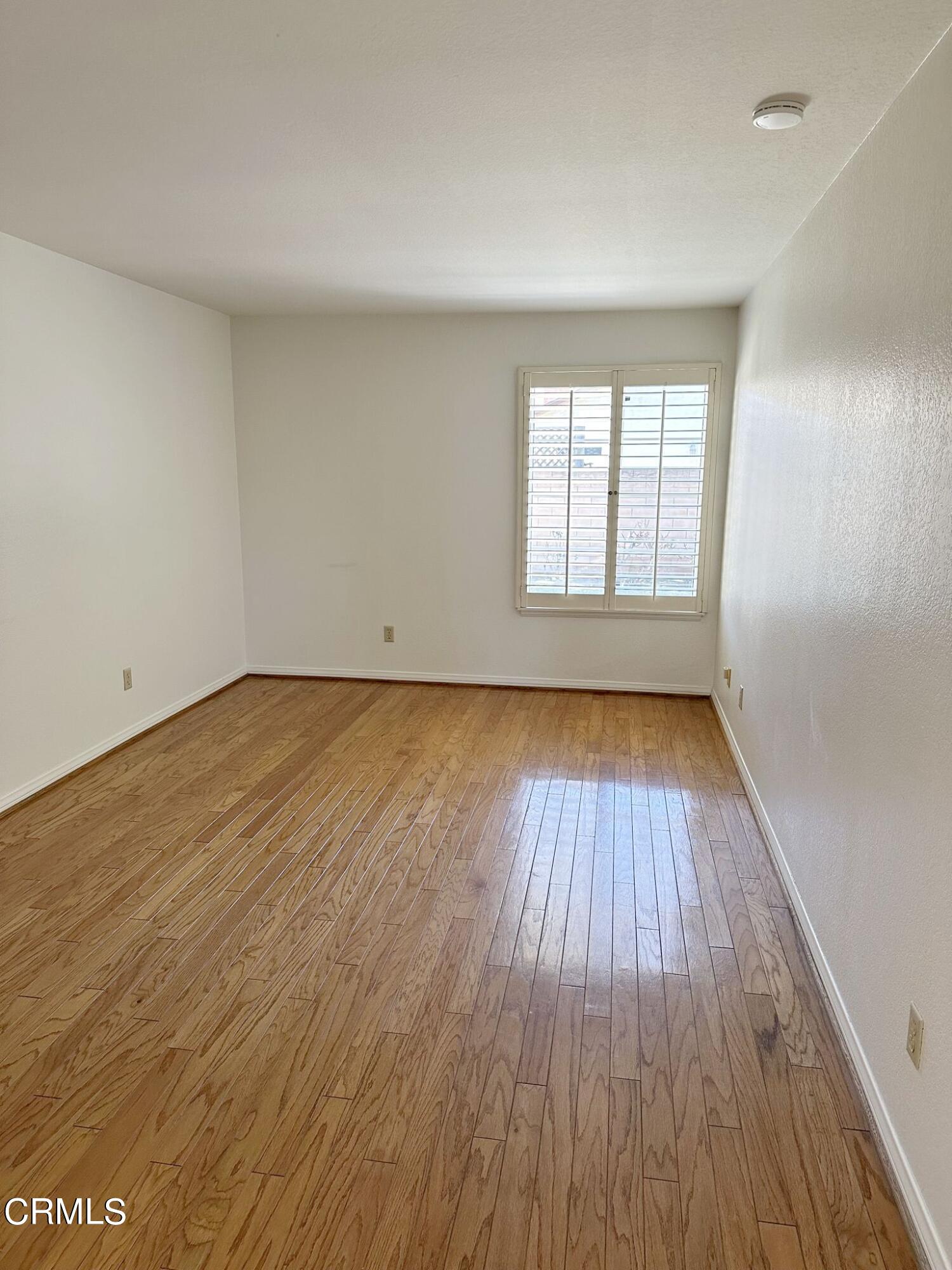 2190 Eastridge Loop Oxnard, CA 93036 - Photo 5 of 21 an empty room with wooden floor and windows