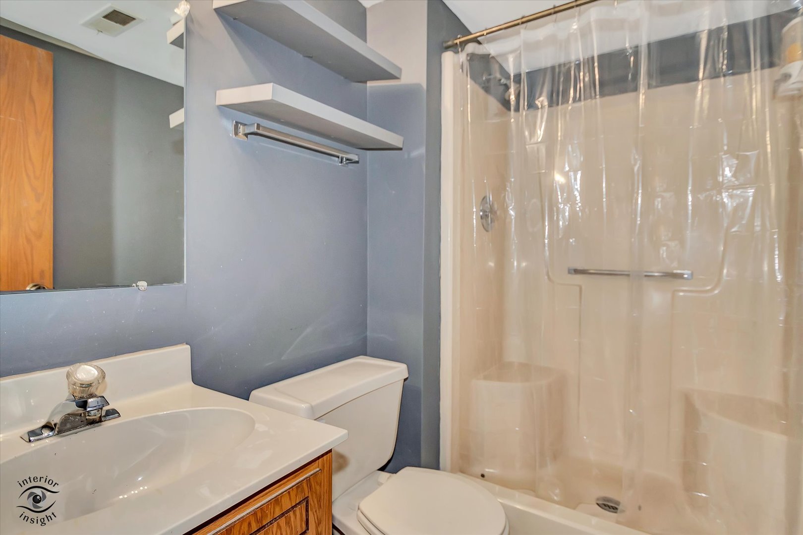 10538 Central Avenue, Unit 1S Chicago Ridge, IL 60415 - Photo 13 of 25 a white toilet sitting next to a bathroom sink