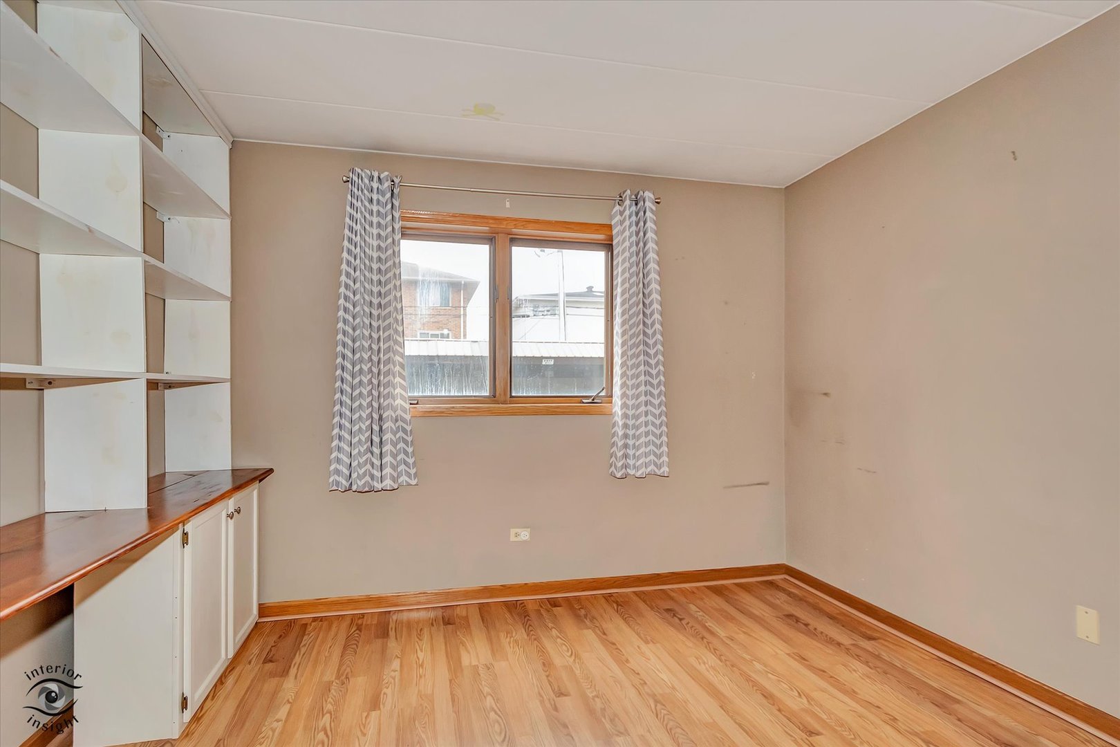 10538 Central Avenue, Unit 1S Chicago Ridge, IL 60415 - Photo 15 of 25 a view of an empty room with wooden floor and a window