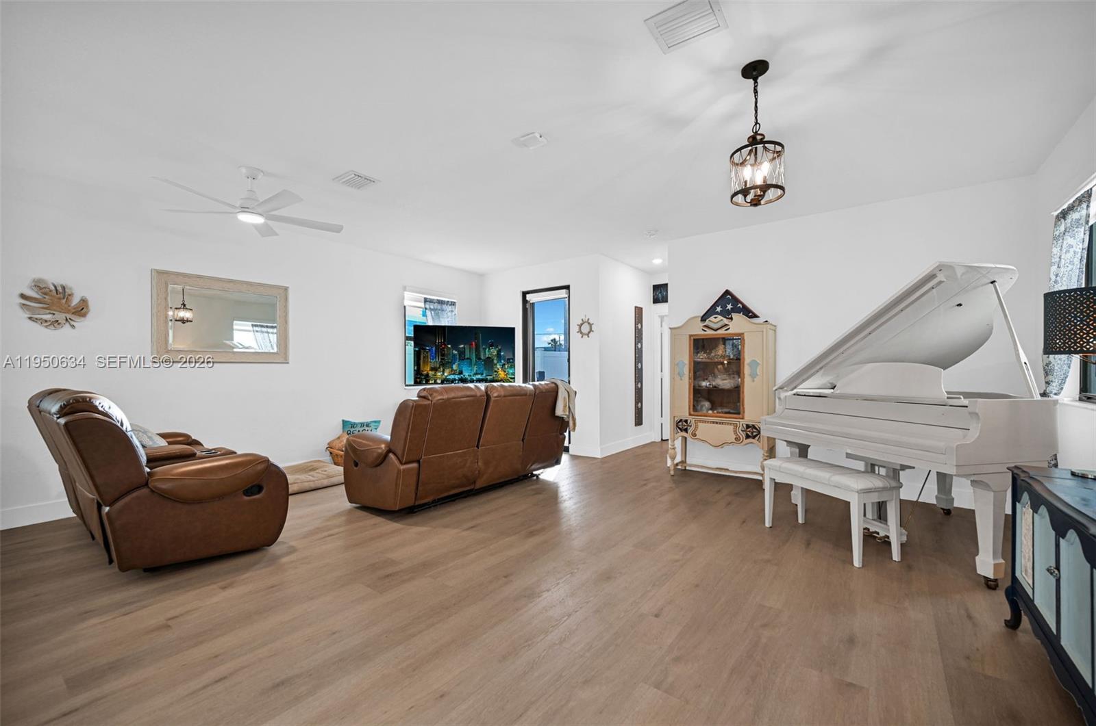10966 West 35th Way Hialeah, FL 33018 - Photo 13 of 48 a living room with furniture and a wooden floor